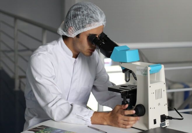 Person looking in microscope